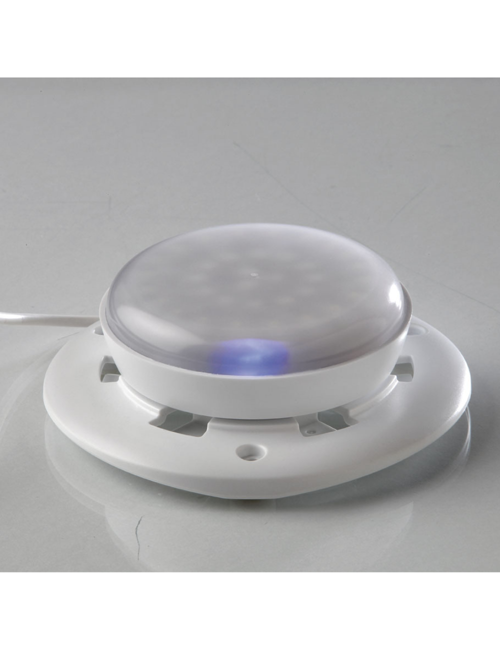 ZIEHER LED light resting on its charging base, while charging