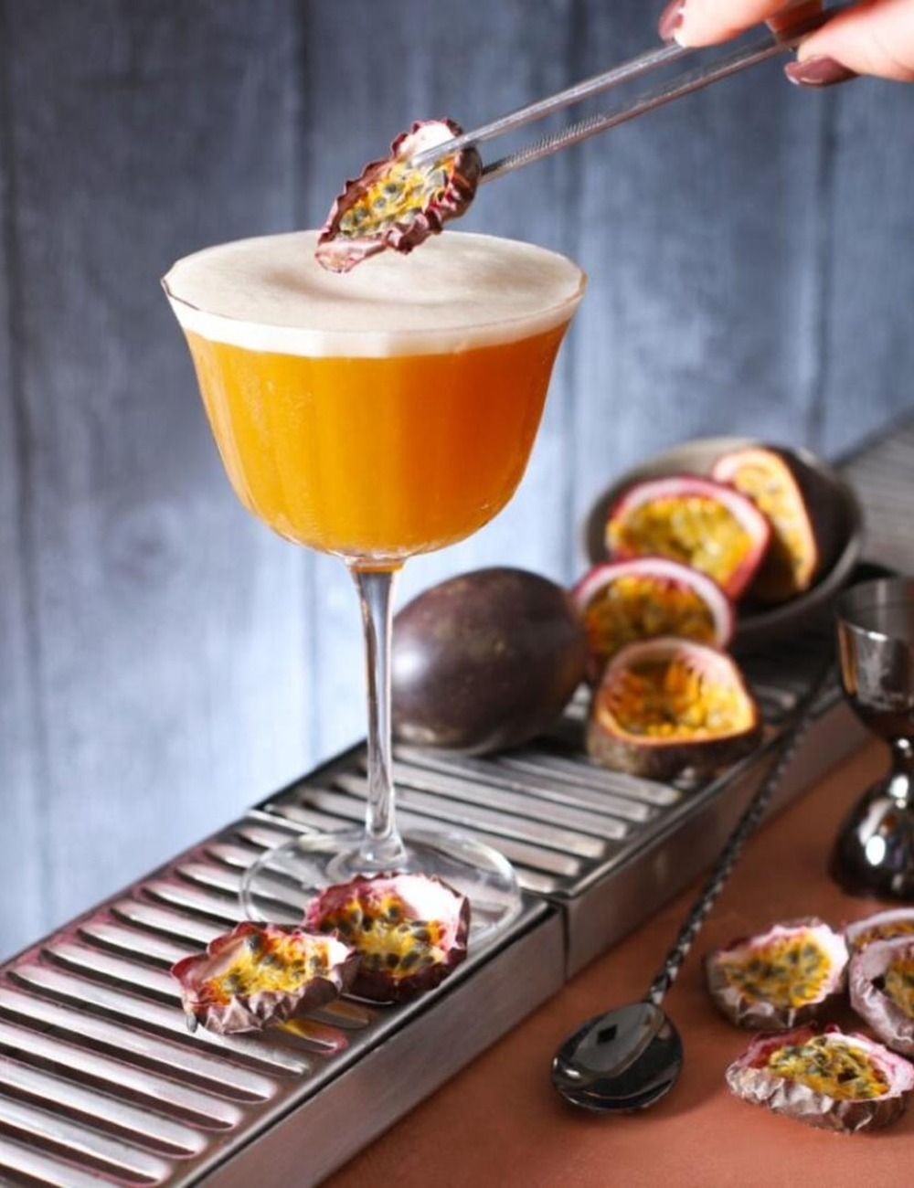 Bar scene featuring a FRONA dried passion fruit slice as a cocktail garnish