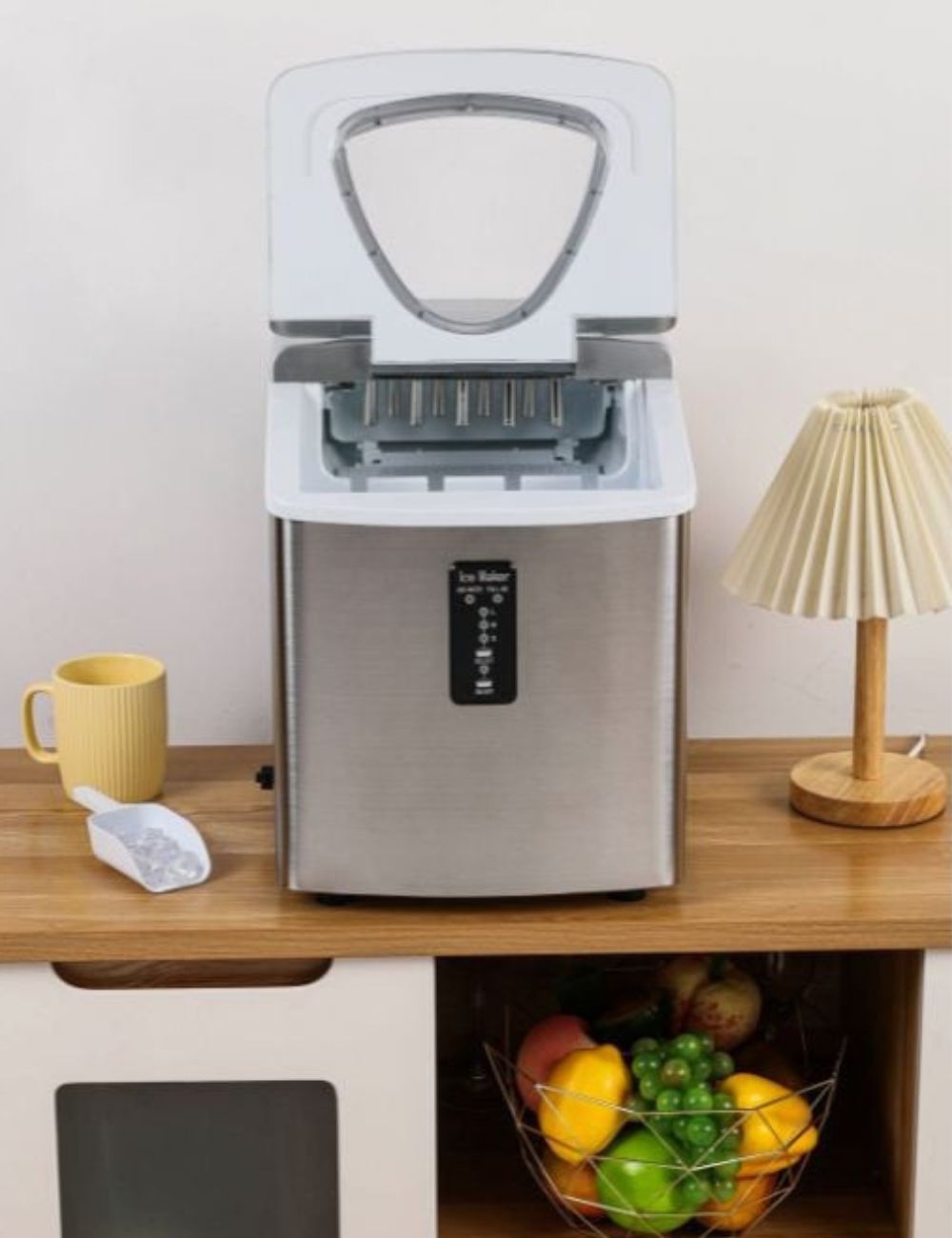 DYNASTEEL ice maker in use, lid open, with its ice scoop