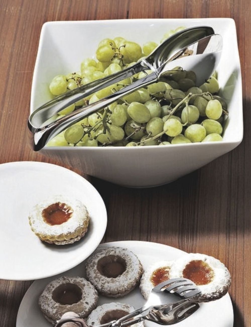 PADERNO Living stainless steel fruit tongs in a bowl of white grapes on a dessert buffet