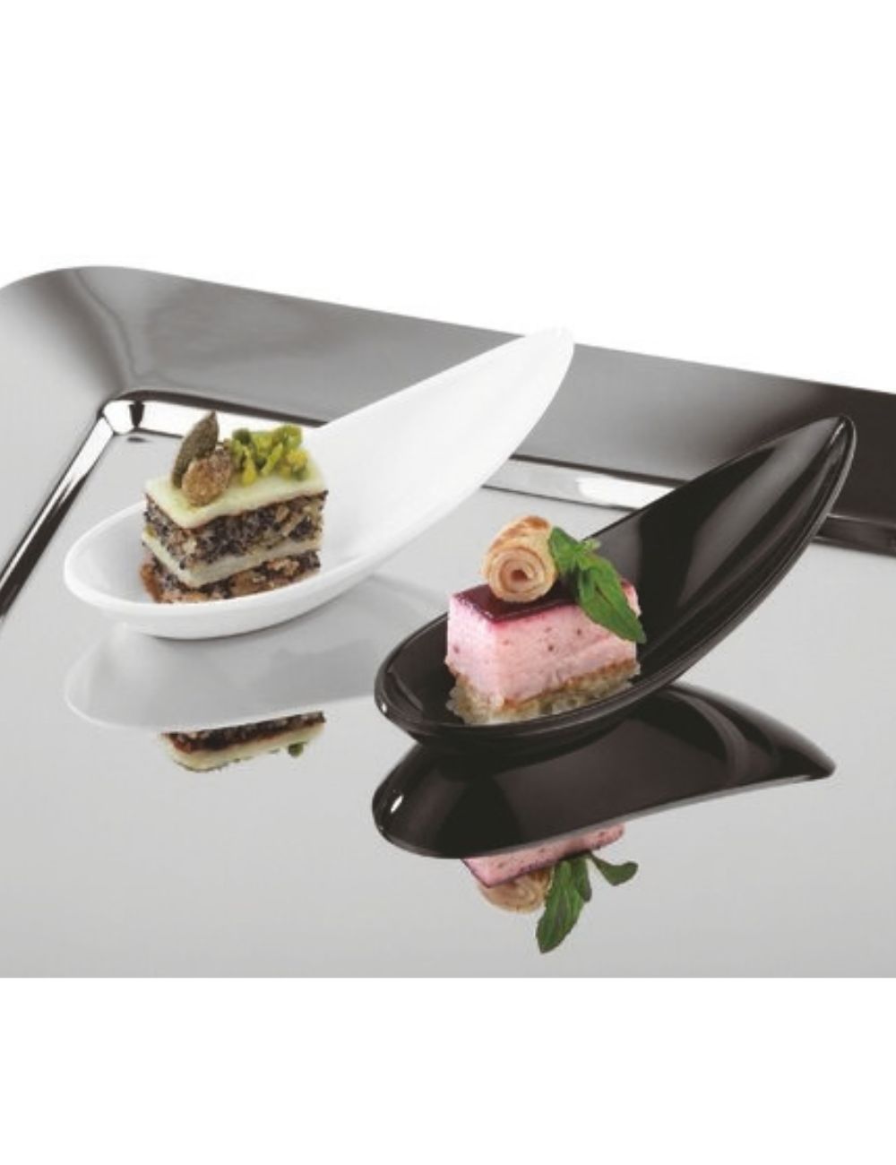 PADERNO white and black boat-shaped amuse-bouche spoons with petits fours on a mirror tray